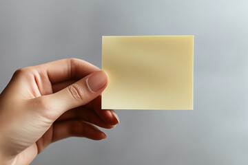 Fototapeta premium the hand holds a piece of paper for writing