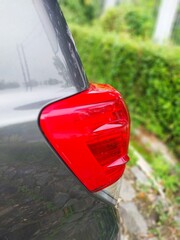 Close-up of a car's rear light, showcasing its sleek design and vibrant colors.
