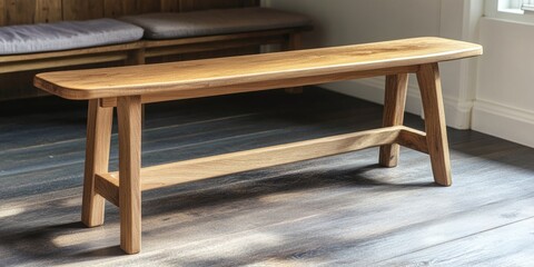 The bench is a simple, minimalist piece of furniture made from natural wood. It adds a warm touch to the contemporary living area with its sturdy construction and elegant design.