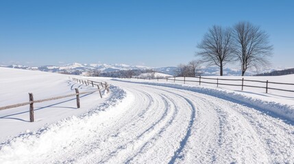 Obraz premium Snowy road curves through winter landscape; mountains background; travel postcard