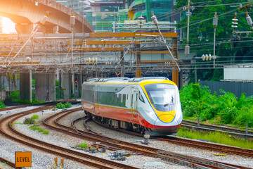 Modern high speed electric train departed from the station to the next point, view of the turn in the city landscape © aapsky