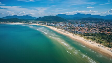 Fototapeta premium Aerial View of Itapema Beach, Brazil: Turquoise Waters, Golden Sands, and Mountain Backdrop
