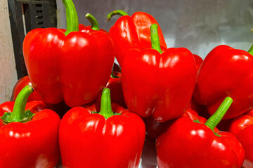 Red bell peppers on the market counter.