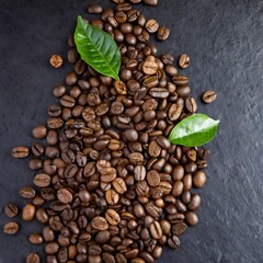 Obraz premium Roasted coffee beans and leaves scattered on dark background