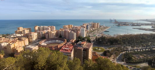 Panoramic view of Malaga featuring Plaza de Toros and port, Spain