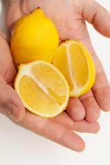lemon in hands on white background