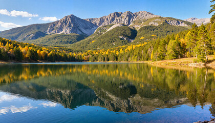 Fototapeta premium Colorful autumn reflection in tranquil lake surrounded by mountains, nature's beauty