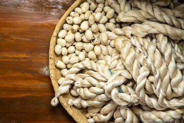 A basket filled with delicate silk threads intertwined with silkworm cocoons