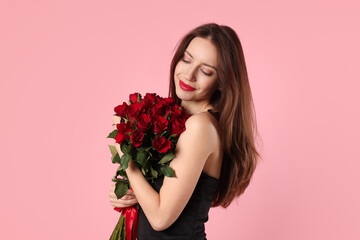 Happy Valentine's Day. Beautiful woman with bouquet of roses on pink background