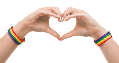 Woman wearing wristband in LGBT colors and making heart gesture on white background, closeup
