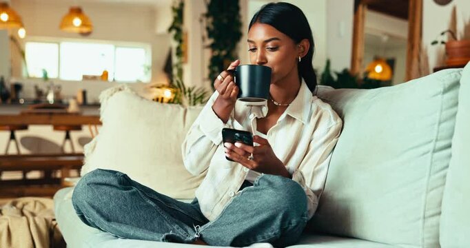 Phone, coffee and woman in home for relax, reading blog and check message on social media. Morning, drink and girl on mobile for online communication, chat app and download ebook on internet on sofa