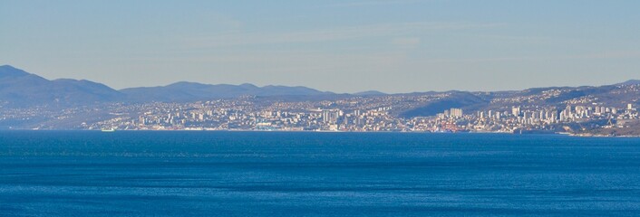 Rijeka, city on Croatian Adriatic sea coastline seen from the Kvarner gulf shoreline and town of Opatija. Third biggest city of Croatia. Croatian town of Rijeka in Kvarner gulf of Adriatic sea.