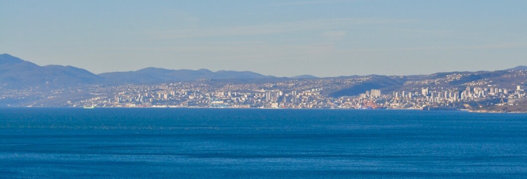 Rijeka, city on Croatian Adriatic sea coastline seen from the Kvarner gulf shoreline and town of Opatija. Third biggest city of Croatia. Croatian town of Rijeka in Kvarner gulf of Adriatic sea.