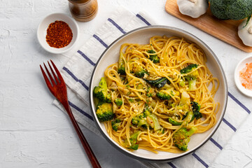 Spaghetti aglio e olio with broccoli, Garlic ,Chili flakes ,Olive Oil and Parmesan Cheese in white plate.Top view.