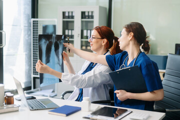 Professional doctors and nurses collaborating on patient care in a modern medical office. Perfect...