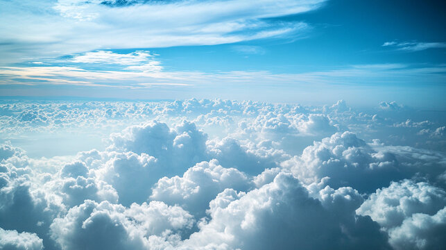 A serene aerial view showcasing fluffy white clouds against a bright blue sky, creating a tranquil and expansive atmosphere.