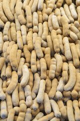 Close-Up of Fresh Brown Tamarind Pods in Bulk Display
