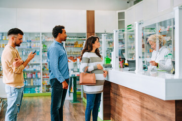 People queueing at pharmacy.