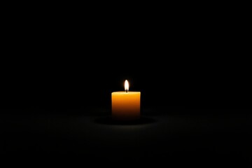 Single candle flame against dark background