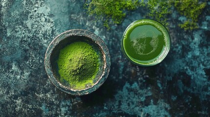 A vibrant green drink beside powdered green substance in a rustic bowl.