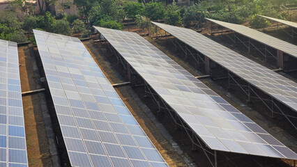 Side angle shot of  Solar panel system near small village in Maharashtra, India