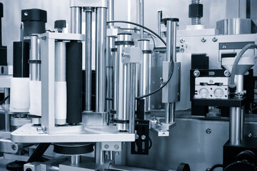 Fragment of the conveyor of sticking labeling machine for packaging food products or pharmaceuticals. Abstract industrial background.