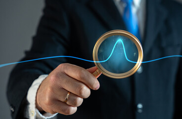 A businessman studies an abnormal jump on a chart. Sales growth. High profitability. Market demand...