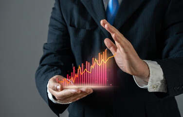 Businessman tries to stop the growth of the red graph. Indicator of high expenses, growth of crime...