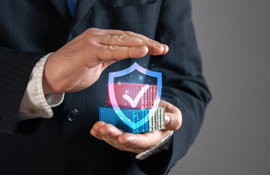 The businessman keeps sea cargo containers under a guarantee of protection. Trade security, logistics protection, freight insurance, supply chain stability, international business. Risk management