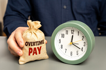 A man holds a money bag with overtime pay near a clock. Concept of additional compensation payment and incentive to work overtime. Wage increases, bonuses, extra hours, payroll benefits for hard work