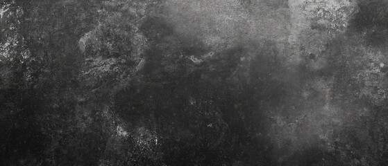 A black, rough concrete wall texture serves as a backdrop with ample copy space. The grunge cement or stone surface offers a dark gray banner, perfect for design and decoration projects.
