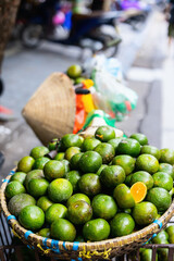 Basket of green oranges for sale