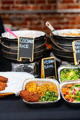 Vegan food display with labeled dishes