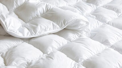 Obraz premium White quilted comforter close-up