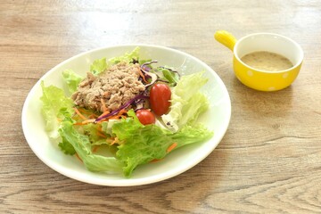 mashed tuna with vegetable salad dressing Japanese roasted sesame cream sauce on plate