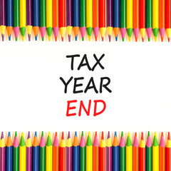 Tax year end symbol. Concept words Tax year end on beautiful white paper. Beautiful white background. Colored pencils. Business tax year end concept. Copy space.