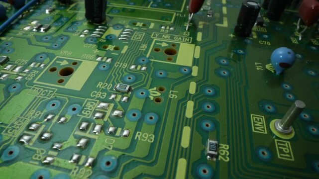 Circuit board with components in rotation. Close up of blue electronic board, with components. 4K UHD Video