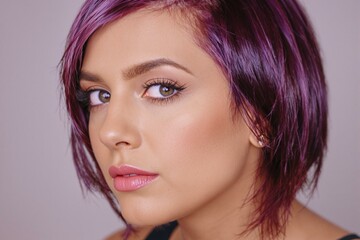 Fototapeta premium Stunning Portrait of a Trendy Woman with Purple Sidecut Hairstyle