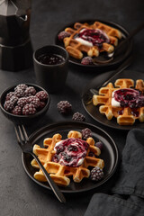 waffles with whipped cream and blackberry sauce