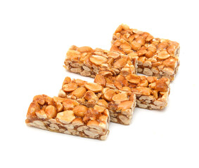 Peanut bars with nuts isolated on white background.
