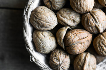 Raw walnuts in baskets on wooden Rustic table. Top view.