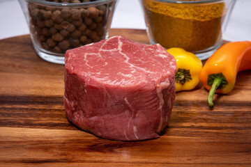 raw beef steak on a wooden board