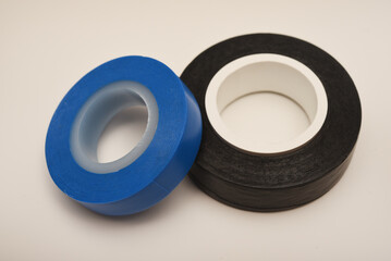 Black and blue electrical tape on a white background. Insulating tape for electronics.