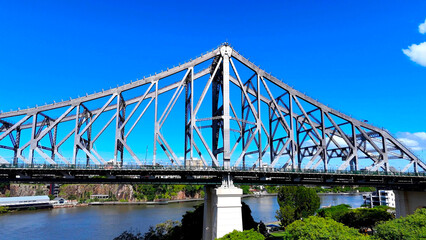 Aerial view of Brisbane River with Story Bridge. The Story Bridge is a heritage-listed steel cantilever bridge spanning the Brisbane River. It is the longest cantilever bridge in Australia. 