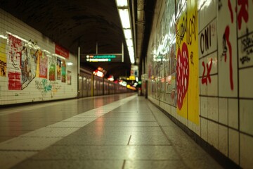 Empty underground subway platform with posters