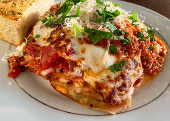 Closeup Of A Slice Of Lasagna On A White Plate