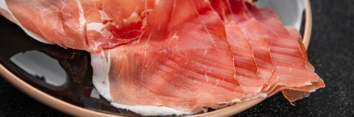Jamon meat fresh iberico or serrano snack aperitif tasty food dish delicious gourmet food background on the table rustic food top view copy space