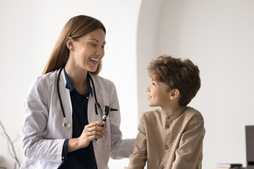 It does not hurt. Laughing young female doctor ENT specialist otorhinolaryngologist pediatrician...