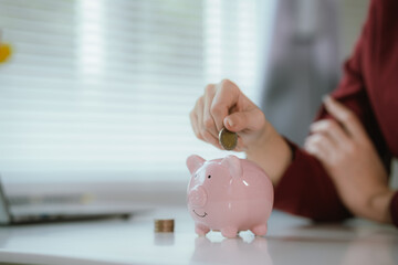 Business women put coin stack money and many bank note in office, Save money for future and Retirement.