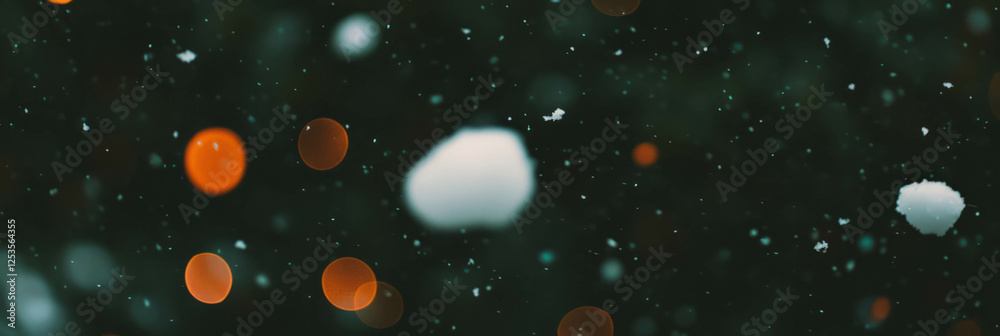 Poster Blurred snowflakes falling through a bright background with soft bokeh circles